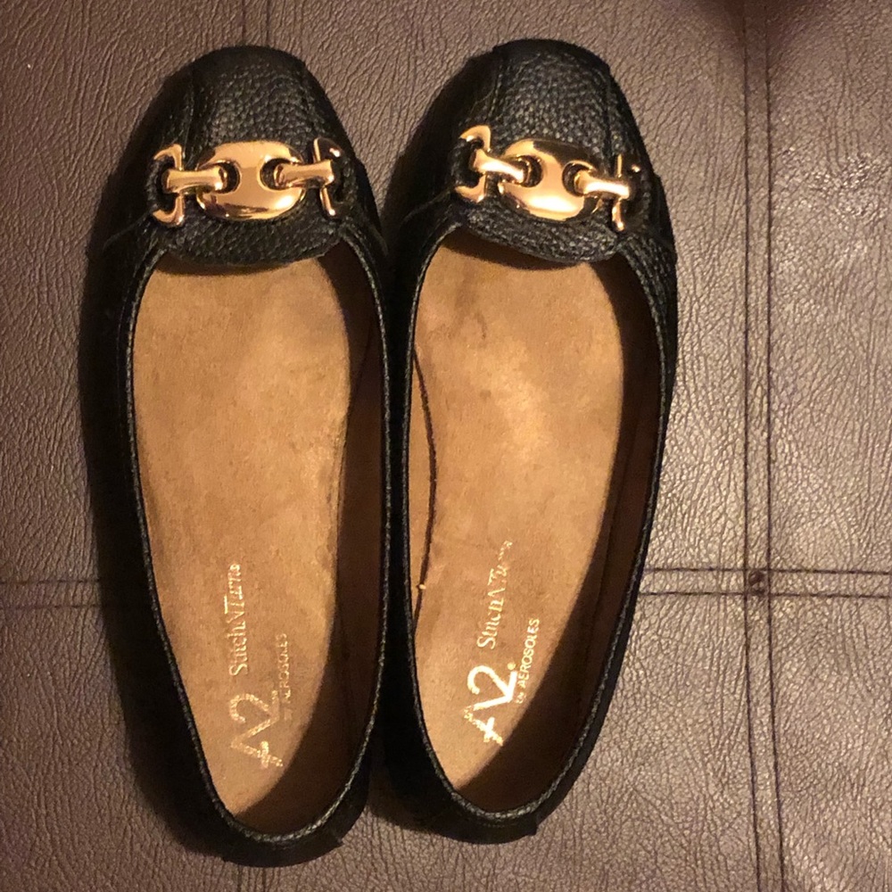Black flats with gold buckle. Worn once.